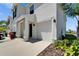 Close-up view of a townhome's exterior highlighting the one-car garage, covered entry, and tidy landscaping at 138 Mangrove Shade Cir, Apollo Beach, FL 33572