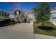 Charming townhome with a well-manicured lawn, inviting entrance, and a spacious driveway leading to an attached garage at 138 Mangrove Shade Cir, Apollo Beach, FL 33572