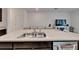 Bright kitchen island with double sinks and view of the dining area and living room at 138 Mangrove Shade Cir, Apollo Beach, FL 33572