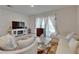 Inviting living room featuring bright natural light and an entertainment center at 138 Mangrove Shade Cir, Apollo Beach, FL 33572