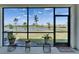 Screened-in patio with picturesque lake views, potted plants, and a 'Welcome' doormat at 138 Mangrove Shade Cir, Apollo Beach, FL 33572