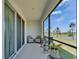 Relaxing screened patio with wicker chairs and scenic lake views at 138 Mangrove Shade Cir, Apollo Beach, FL 33572