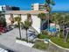 Aerial view of property with palm trees, pool, beach access and proximity to the ocean at 1412 Gulf Blvd # 103A, Indian Rocks Beach, FL 33785