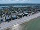 Sweeping aerial view of beachside properties with pristine sands and views of the Gulf Coast at 1412 Gulf Blvd # 103A, Indian Rocks Beach, FL 33785