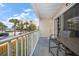 Balcony overlooking the parking and nearby buildings with palm trees at 1412 Gulf Blvd # 103A, Indian Rocks Beach, FL 33785