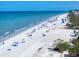 Panoramic view of the beach, showcasing white sand, clear blue water, and beachgoers at 1412 Gulf Blvd # 103A, Indian Rocks Beach, FL 33785