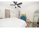 Inviting bedroom with a wooden bed frame, blue dresser, and wood-look flooring at 1412 Gulf Blvd # 103A, Indian Rocks Beach, FL 33785
