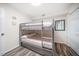 Cozy bedroom with hardwood floors features a gray bunkbed, perfect for or guests at 1412 Gulf Blvd # 103A, Indian Rocks Beach, FL 33785