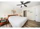 Comfortable bedroom with a wooden bed, ceiling fan, and access to the bathroom at 1412 Gulf Blvd # 103A, Indian Rocks Beach, FL 33785