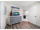 Bright bedroom with gray dresser, television, coastal decor and wood-look floors at 1412 Gulf Blvd # 103A, Indian Rocks Beach, FL 33785