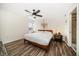 Cozy bedroom featuring a wooden bed frame, ceiling fan, and wood-look flooring at 1412 Gulf Blvd # 103A, Indian Rocks Beach, FL 33785