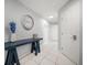 Inviting hallway features modern table, decorations, and tiled flooring at 1412 Gulf Blvd # 103A, Indian Rocks Beach, FL 33785