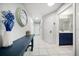 Tiled hallway featuring modern table and accents with convenient access to the bathroom at 1412 Gulf Blvd # 103A, Indian Rocks Beach, FL 33785