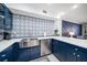 A modern kitchen with quartz countertops and stainless steel appliances, perfect for cooking and entertaining at 1412 Gulf Blvd # 103A, Indian Rocks Beach, FL 33785