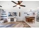 Inviting living room featuring a ceiling fan, flatscreen TV, and adjacent dining area at 1412 Gulf Blvd # 103A, Indian Rocks Beach, FL 33785