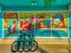 Charming building featuring a vibrant 'Greetings From Florida' mural and bicycles parked in front at 1412 Gulf Blvd # 103A, Indian Rocks Beach, FL 33785