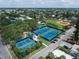 Well-maintained tennis courts next to baseball field surrounded by lush landscaping and mature trees at 1412 Gulf Blvd # 103A, Indian Rocks Beach, FL 33785