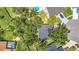 Aerial view showcasing the property, swimming pool, and tree-lined neighborhood at 1530 High Knoll Dr, Brandon, FL 33511