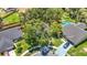 Aerial view of a home featuring a pool, mature trees, and well-kept landscaping at 1530 High Knoll Dr, Brandon, FL 33511