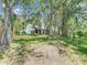 Expansive backyard featuring mature trees, lush lawn, and rear house facade at 1530 High Knoll Dr, Brandon, FL 33511