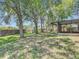 Beautiful backyard features mature trees, a lush lawn, and a screened patio at 1530 High Knoll Dr, Brandon, FL 33511