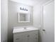 The bathroom boasts a sleek vanity, mirror, and contemporary lighting, creating a relaxing retreat at 1530 High Knoll Dr, Brandon, FL 33511