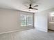 Bright bedroom features a large window overlooking a landscaped yard and neutral paint scheme at 1530 High Knoll Dr, Brandon, FL 33511