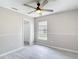 A neutral bedroom features a ceiling fan, window, and modern flooring, creating a bright, airy space at 1530 High Knoll Dr, Brandon, FL 33511