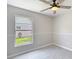 A cozy bedroom featuring a ceiling fan, and a window with a view of the outdoors, offers a relaxing atmosphere at 1530 High Knoll Dr, Brandon, FL 33511