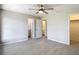 Spacious bedroom features ceiling fan and tiled floor, with walk-in closet and an ensuite bathroom at 1530 High Knoll Dr, Brandon, FL 33511