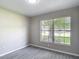 Bright bedroom with a large window letting in plenty of natural light and wood look tile flooring at 1530 High Knoll Dr, Brandon, FL 33511