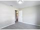 This bedroom features fresh paint, wood-look tile flooring, and a view to the dining room at 1530 High Knoll Dr, Brandon, FL 33511
