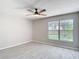 Bedroom featuring a ceiling fan and a window offering natural light and scenic views, creating a comfortable retreat at 1530 High Knoll Dr, Brandon, FL 33511