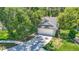 View of a home with attached garage and a driveway, with mature trees and green lawn at 1530 High Knoll Dr, Brandon, FL 33511