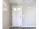 White front door with glass panes offering natural light, set against neutral wall color at 1530 High Knoll Dr, Brandon, FL 33511