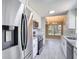 Beautiful and bright kitchen with stainless appliances including refrigerator, microwave, dishwasher, and stove overlooking dining area at 1530 High Knoll Dr, Brandon, FL 33511