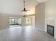 Bright living area boasts high ceilings, tiled floors, fireplace, and screened-in patio access at 1530 High Knoll Dr, Brandon, FL 33511