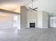 Open-concept living room showcases a fireplace, modern tile floors, and kitchen access at 1530 High Knoll Dr, Brandon, FL 33511