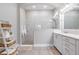 Bathroom showcasing double vanity with stone countertops and a large walk-in shower at 16677 Vibrato Ln, Land O Lakes, FL 34638