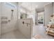Bright, luxury bathroom with large glass shower, chrome fixtures, and access to main bedroom at 16677 Vibrato Ln, Land O Lakes, FL 34638