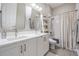 Bright bathroom features double sinks, modern fixtures, and a shower-tub combination with white tile at 16677 Vibrato Ln, Land O Lakes, FL 34638