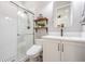 Modern bathroom with glass shower, updated vanity, and stylish black and white tile flooring at 16677 Vibrato Ln, Land O Lakes, FL 34638
