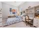 Cozy bedroom with built-in shelving, a comfortable bed, and bright decor accents at 16677 Vibrato Ln, Land O Lakes, FL 34638