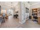 Welcoming foyer flows into an office with a custom bookcase and piano in the entry at 16677 Vibrato Ln, Land O Lakes, FL 34638