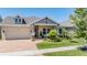 Inviting single-story home featuring manicured landscaping and a brick driveway leading to an attached two-car garage at 16677 Vibrato Ln, Land O Lakes, FL 34638