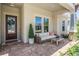 Charming front porch with comfortable seating and a decorative wreath, creating a welcoming entrance at 16677 Vibrato Ln, Land O Lakes, FL 34638