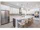 Bright and airy kitchen with a large island, stainless steel appliances, and ample cabinet space at 16677 Vibrato Ln, Land O Lakes, FL 34638