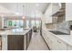 Modern open-concept kitchen with a large island, sleek countertops, and high-end appliances at 16677 Vibrato Ln, Land O Lakes, FL 34638