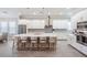 Spacious kitchen with white cabinetry, a large center island with seating, and stainless steel appliances at 16677 Vibrato Ln, Land O Lakes, FL 34638