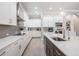 Stylish kitchen with stainless steel appliances, white cabinets, and a spacious center island at 16677 Vibrato Ln, Land O Lakes, FL 34638